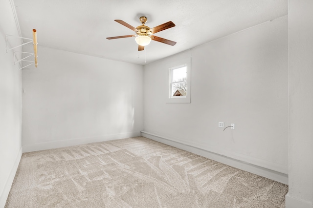 spare room featuring ceiling fan and light carpet