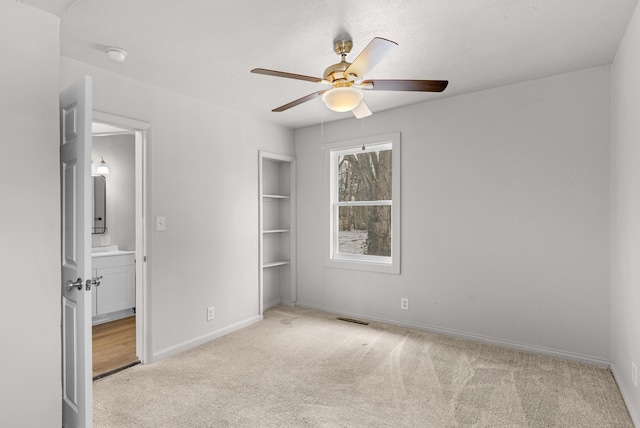 unfurnished bedroom featuring ceiling fan, light carpet, and a closet