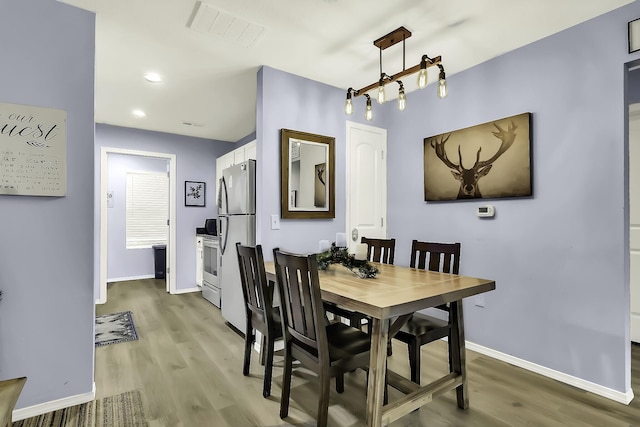 dining area with hardwood / wood-style floors