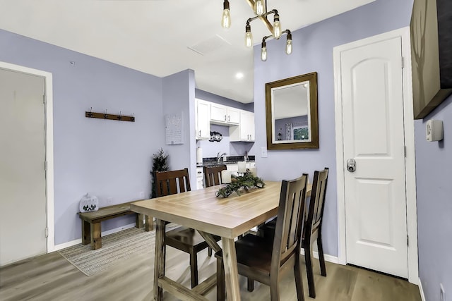 dining space with dark hardwood / wood-style flooring and sink