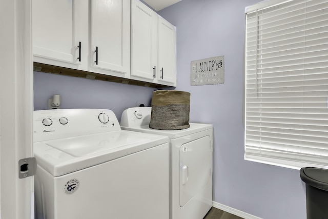 laundry room featuring separate washer and dryer and cabinets