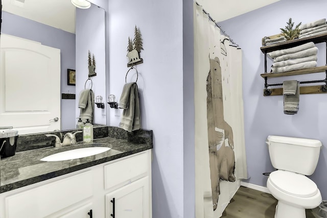 bathroom with vanity, toilet, wood-type flooring, and walk in shower