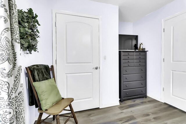 living area with hardwood / wood-style flooring