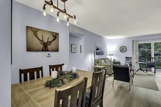 dining space featuring wood-type flooring