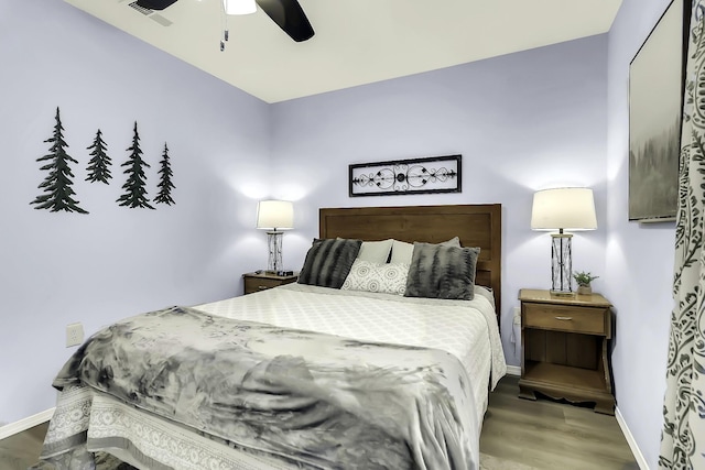 bedroom with hardwood / wood-style floors and ceiling fan