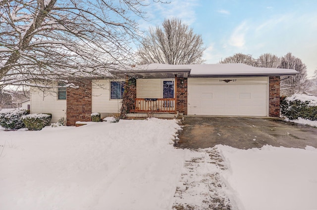 single story home with a porch and a garage