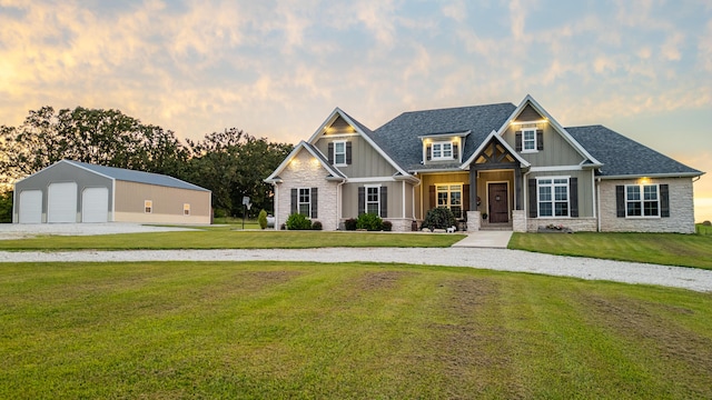 craftsman inspired home with an outbuilding, a yard, and a garage