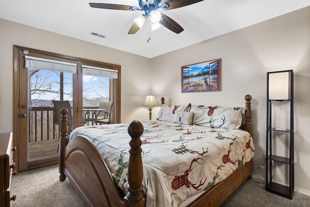 carpeted bedroom featuring access to outside, ceiling fan, and a textured ceiling