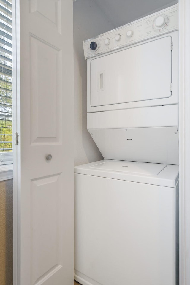 laundry area featuring stacked washer / dryer