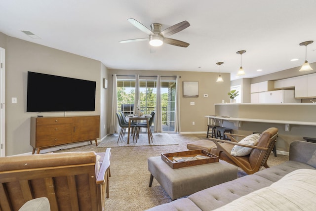 living room with light carpet and ceiling fan