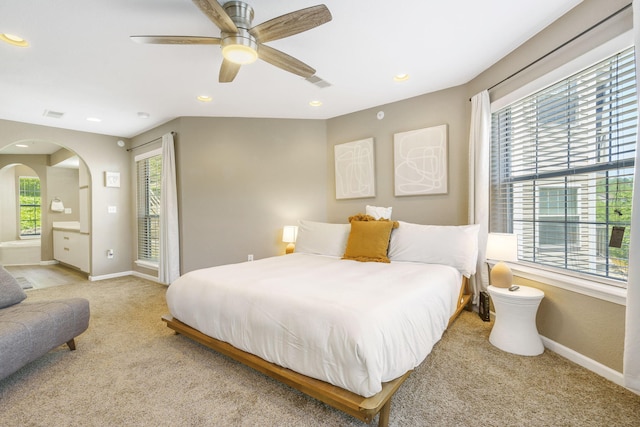 carpeted bedroom featuring multiple windows and ceiling fan