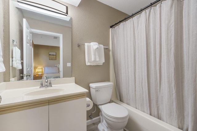 full bathroom featuring vanity, shower / bath combination with curtain, and toilet