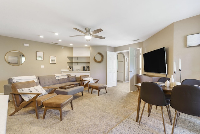 carpeted living room featuring ceiling fan