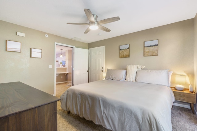 carpeted bedroom featuring connected bathroom and ceiling fan