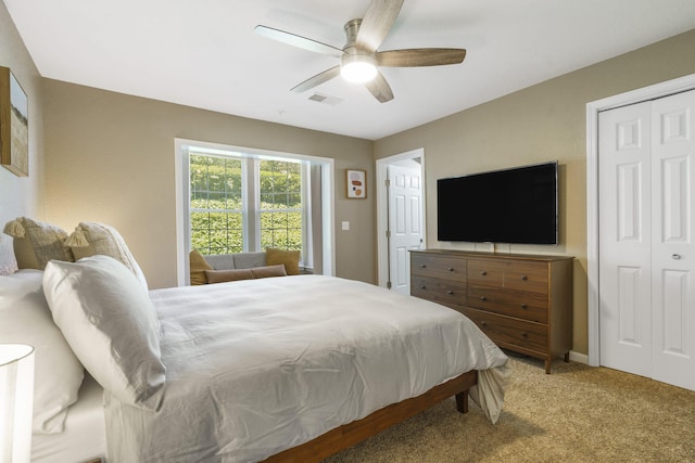 bedroom featuring ceiling fan, a closet, and carpet