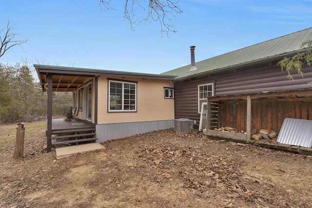 view of side of property with cooling unit and a wooden deck