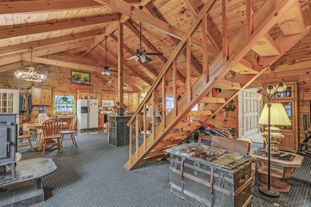 unfurnished living room featuring wooden walls, beamed ceiling, and wood ceiling