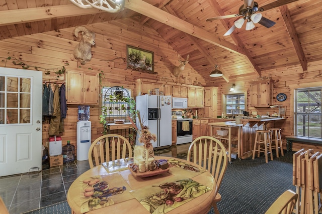 tiled dining room featuring beam ceiling, wooden walls, and wood ceiling