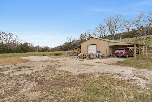 view of outbuilding featuring a carport and a garage