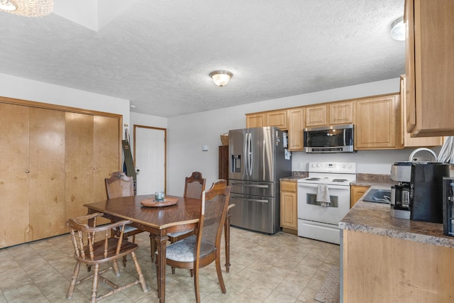 kitchen featuring appliances with stainless steel finishes and a textured ceiling