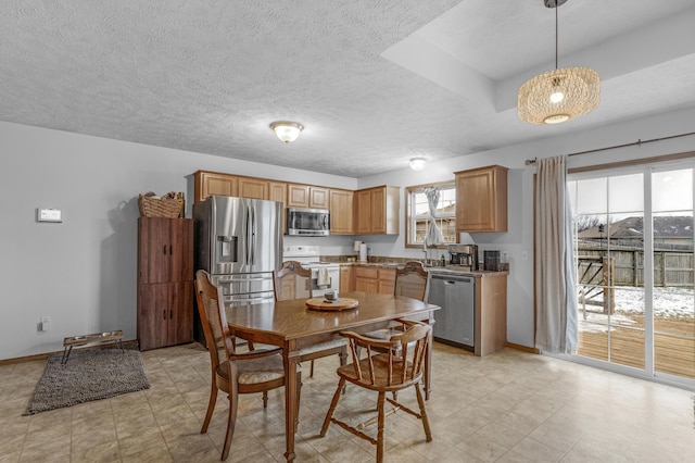 kitchen featuring decorative light fixtures, stainless steel appliances, and sink