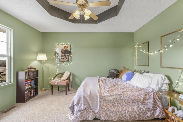 bedroom featuring carpet flooring, ceiling fan, and a textured ceiling