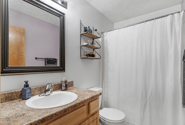 bathroom with vanity, a textured ceiling, and toilet