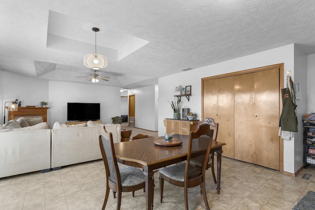 dining room featuring a textured ceiling and ceiling fan