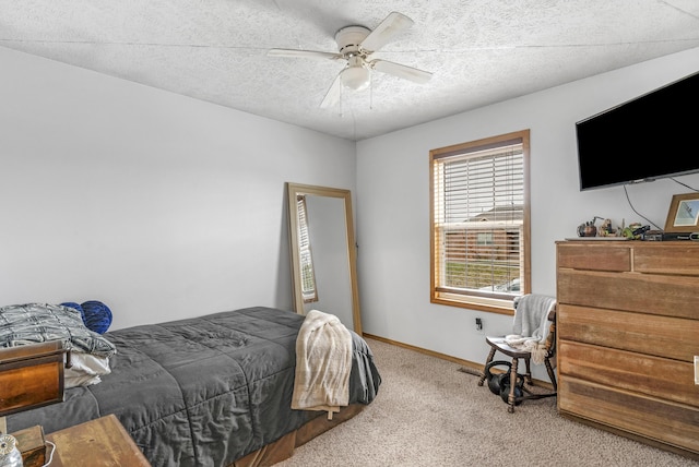 carpeted bedroom with ceiling fan and a textured ceiling