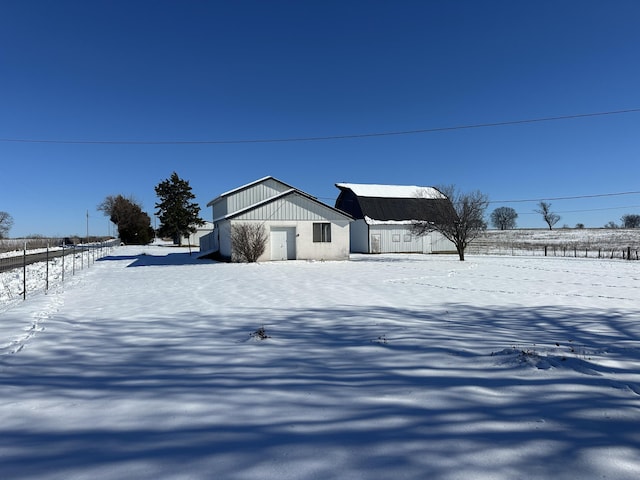 snowy yard featuring an outdoor structure