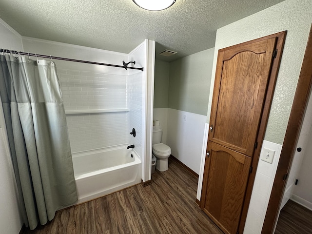 bathroom with hardwood / wood-style floors, a textured ceiling, toilet, and shower / bath combo