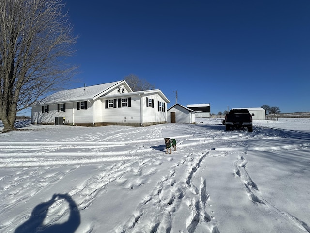 view of front of property featuring cooling unit and an outdoor structure