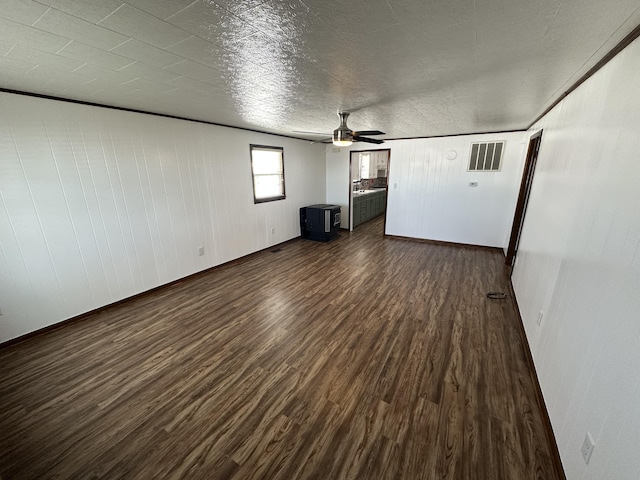 unfurnished living room featuring dark hardwood / wood-style floors and ceiling fan