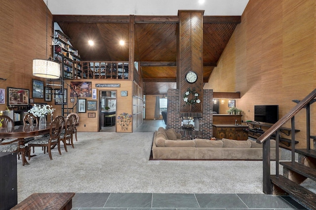 living room featuring high vaulted ceiling and beamed ceiling