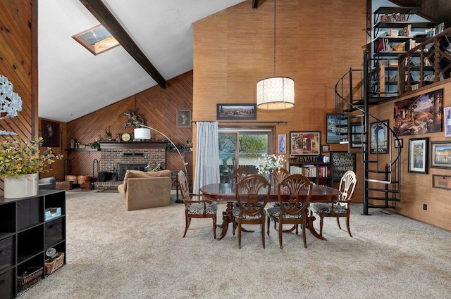 dining space with carpet floors, high vaulted ceiling, beam ceiling, and a brick fireplace