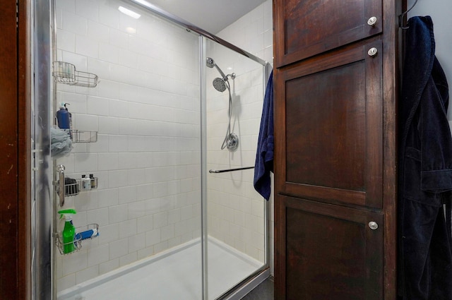 bathroom featuring a shower with door