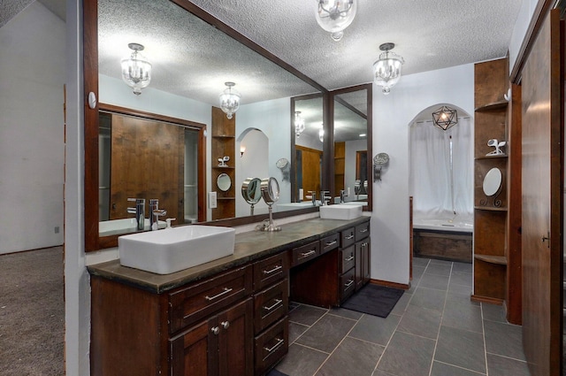 bathroom featuring a textured ceiling and vanity