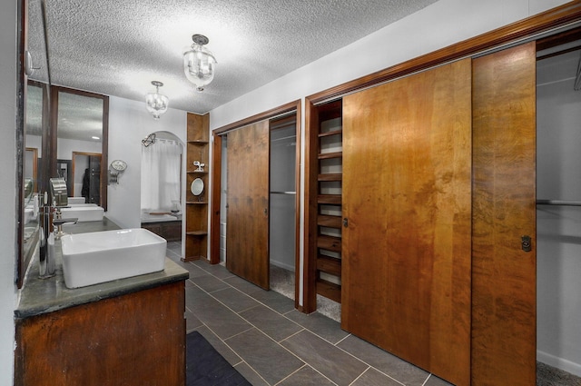 bathroom featuring vanity and a textured ceiling