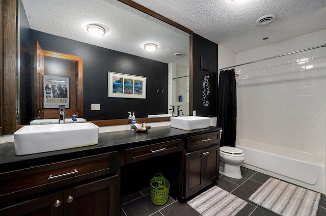 full bathroom featuring toilet, tile patterned floors, vanity, shower / bath combo, and a textured ceiling