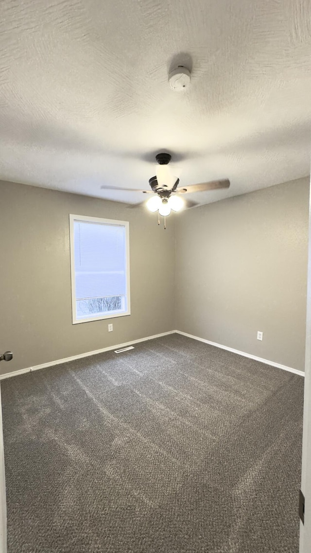 empty room with ceiling fan and carpet floors