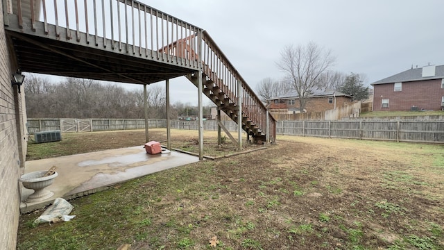 view of yard featuring a deck and central air condition unit