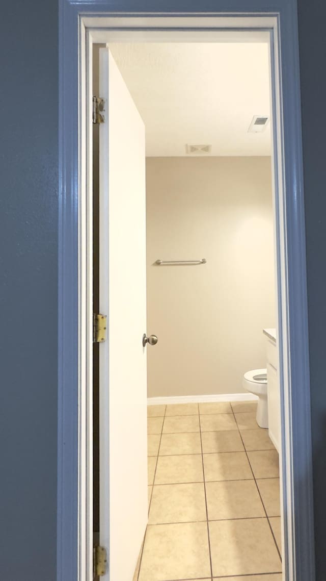 bathroom with tile patterned flooring and toilet