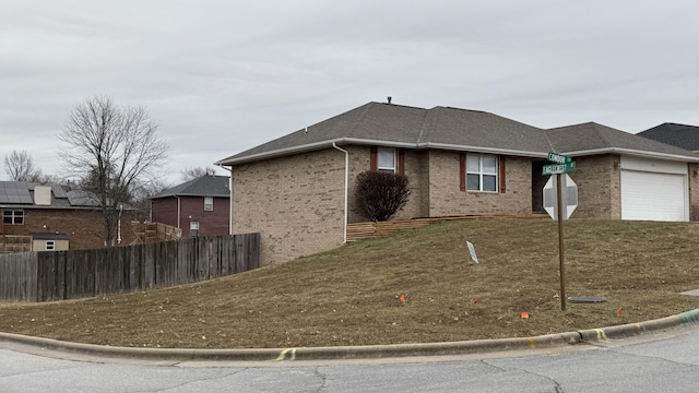 view of home's exterior with a yard and a garage