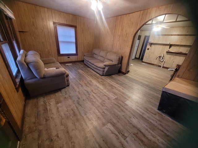 living room with hardwood / wood-style floors and wood walls