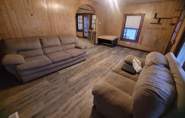 living room with wood-type flooring and wood walls