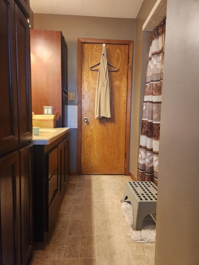 bathroom featuring vanity and a textured ceiling