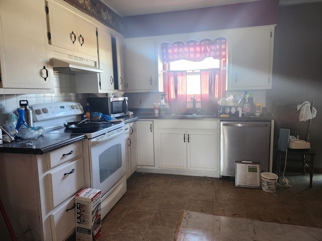 kitchen with stainless steel appliances, sink, white cabinets, and backsplash