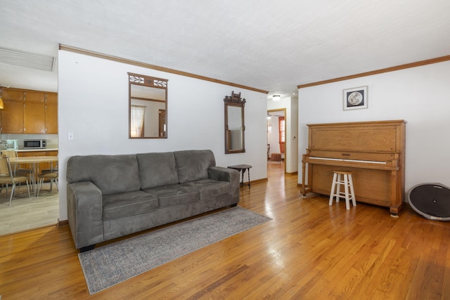 living room featuring light wood-type flooring and crown molding