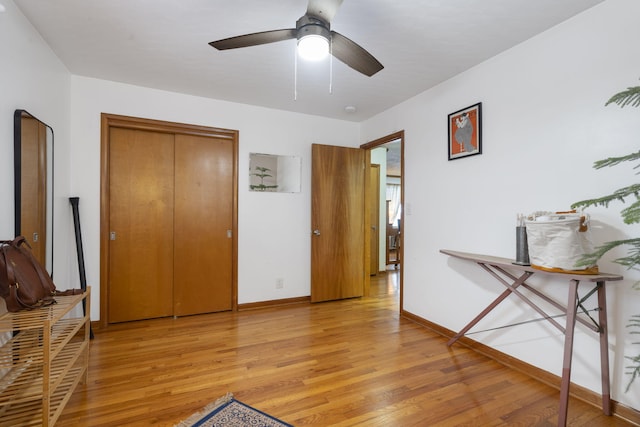 bedroom featuring light wood-type flooring, a closet, and ceiling fan