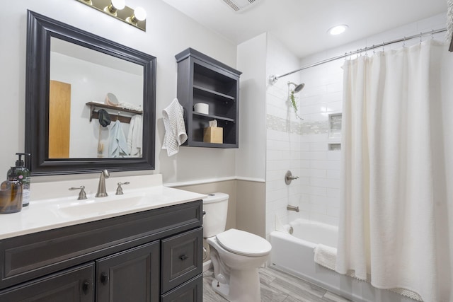 full bathroom featuring vanity, shower / bath combination with curtain, and toilet